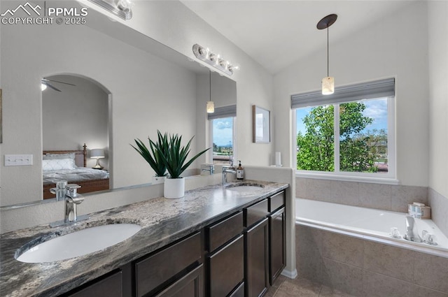 8795 Canary Cir, Colorado Springs, CO 80908 - ensuite bathroom with double vanity, a garden tub, vaulted ceiling, and tile patterned floors