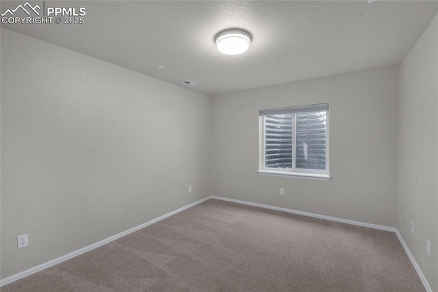 8795 Canary Cir, Colorado Springs, CO 80908 - carpeted spare room with baseboards and a textured ceiling