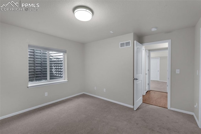 8795 Canary Cir, Colorado Springs, CO 80908 - unfurnished bedroom with carpet floors, baseboards, and a textured ceiling
