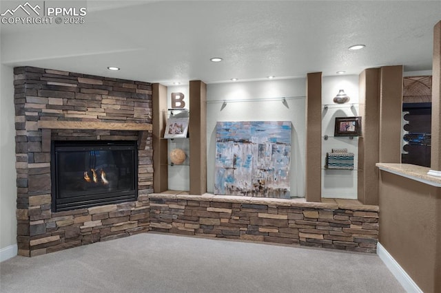 8795 Canary Cir, Colorado Springs, CO 80908 - unfurnished living room with carpet flooring, a stone fireplace, baseboards, and recessed lighting