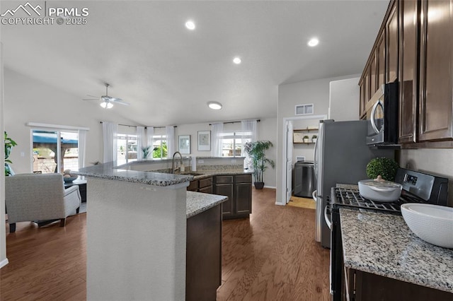 8795 Canary Cir, Colorado Springs, CO 80908 - kitchen with range with gas stovetop, a sink, stainless steel microwave, dark brown cabinets, and recessed lighting