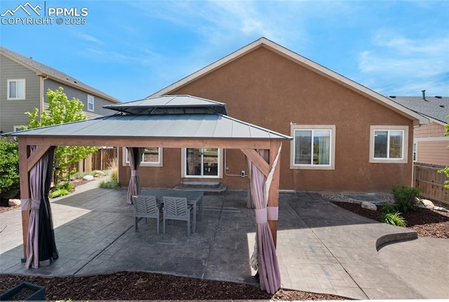 8795 Canary Cir, Colorado Springs, CO 80908 - back of property with a gazebo, stucco siding, and a patio