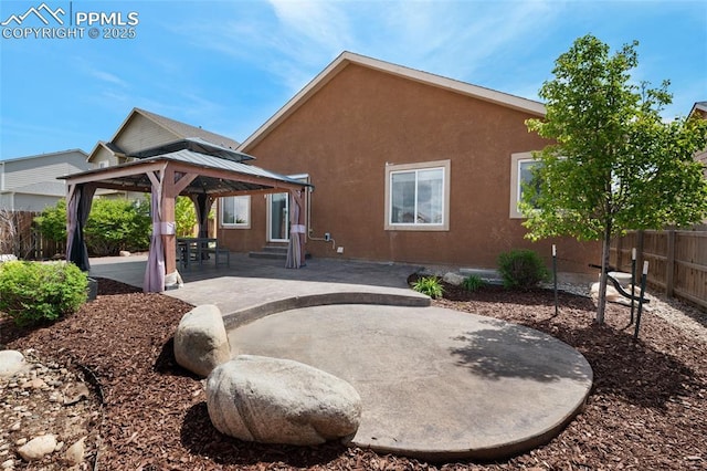 8795 Canary Cir, Colorado Springs, CO 80908 - rear view of house with a gazebo, a patio area, and stucco siding
