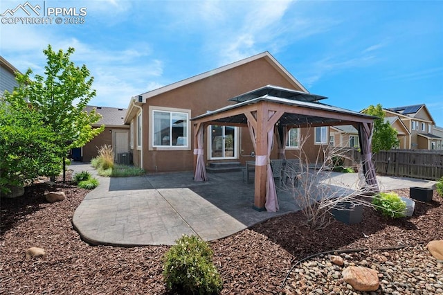 8795 Canary Cir, Colorado Springs, CO 80908 - rear view of house with stucco siding, a patio area, central AC, and a gazebo