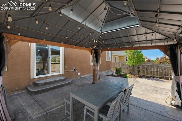 8795 Canary Cir, Colorado Springs, CO 80908 - view of patio / terrace featuring a gazebo, outdoor dining space, and entry steps