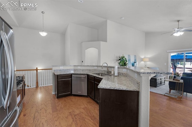 8795 Canary Cir, Colorado Springs, CO 80908 - kitchen with stainless steel appliances, a sink, lofted ceiling, ceiling fan, and light wood-style floors