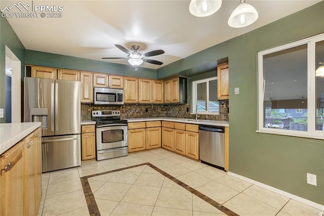 4708 Sprucewood Dr, Colorado Springs, CO 80918 - kitchen featuring stainless steel appliances, tasteful backsplash, a sink, and light countertops