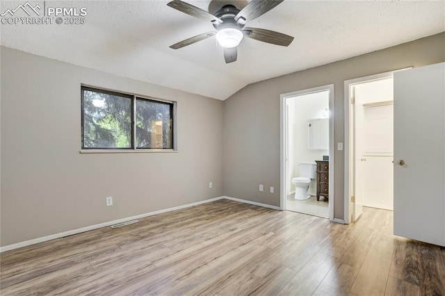 4708 Sprucewood Dr, Colorado Springs, CO 80918 - unfurnished bedroom with wood finished floors, vaulted ceiling, connected bathroom, baseboards, and a ceiling fan