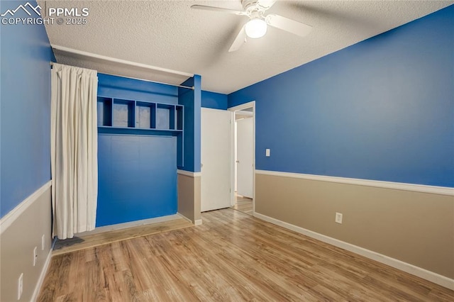 4708 Sprucewood Dr, Colorado Springs, CO 80918 - spare room with wood finished floors, a textured ceiling, ceiling fan, and baseboards