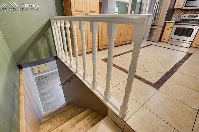 4708 Sprucewood Dr, Colorado Springs, CO 80918 - stairway featuring baseboards, tile patterned flooring, and a textured wall