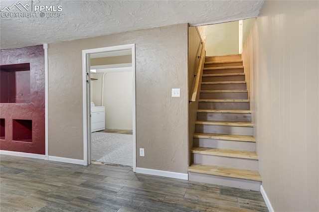 4708 Sprucewood Dr, Colorado Springs, CO 80918 - stairway with wood finished floors, a textured ceiling, washer / clothes dryer, baseboards, and a textured wall