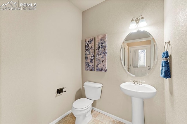 7315 Forest Meadows Ave, Colorado Springs, CO 80908 - bathroom with toilet, baseboards, and a sink