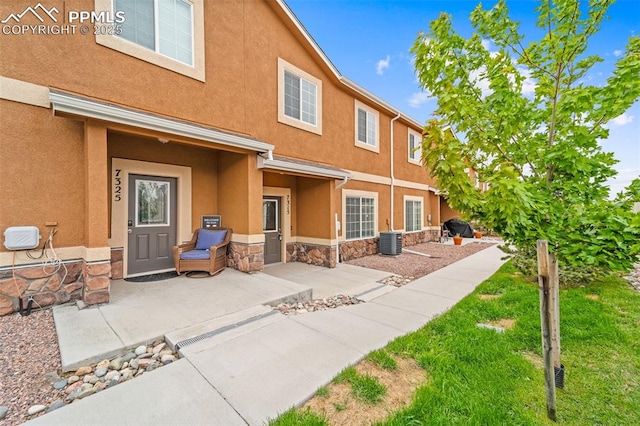 7315 Forest Meadows Ave, Colorado Springs, CO 80908 - back of property with stone siding, central AC unit, and stucco siding