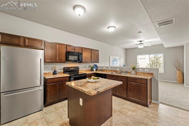 7315 Forest Meadows Ave, Colorado Springs, CO 80908 - kitchen with black appliances, a peninsula, a sink, ceiling fan, and a kitchen island