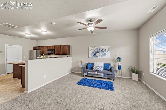7315 Forest Meadows Ave, Colorado Springs, CO 80908 - living area with light colored carpet, ceiling fan, and baseboards