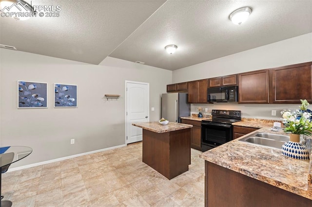 7315 Forest Meadows Ave, Colorado Springs, CO 80908 - kitchen with black appliances, a center island, a sink, a textured ceiling, and baseboards