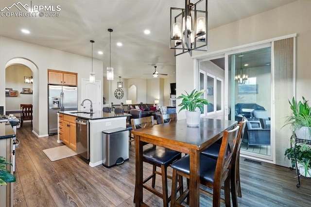 15506 Short Line Ct, Monument, CO 80132 - kitchen featuring a chandelier, stainless steel appliances, dark countertops, a sink, and ceiling fan
