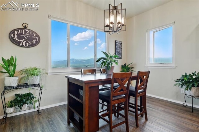 15506 Short Line Ct, Monument, CO 80132 - dining room with a chandelier, dark wood finished floors, and baseboards