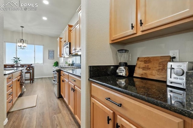 15506 Short Line Ct, Monument, CO 80132 - kitchen with appliances with stainless steel finishes, light wood finished floors, recessed lighting, dark stone counters, and a chandelier