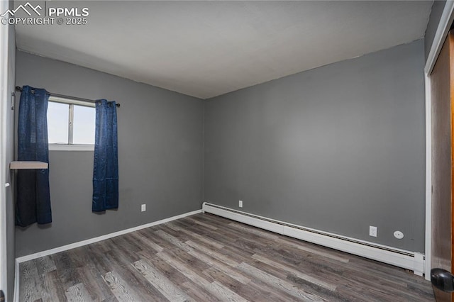 9940 N Calhan Hwy, Calhan, CO 80808 - empty room featuring a baseboard heating unit, wood finished floors, and baseboards