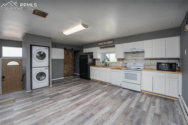 9940 N Calhan Hwy, Calhan, CO 80808 - kitchen with black appliances, estacked washer and dryer, a barn door, wood counters, and light wood finished floors