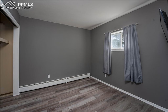 9940 N Calhan Hwy, Calhan, CO 80808 - unfurnished bedroom featuring baseboard heating, wood finished floors, and baseboards