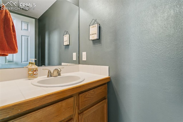 7942 French Rd, Colorado Springs, CO 80920 - bathroom featuring vanity and a textured wall