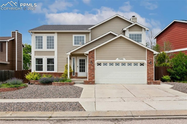 7942 French Rd, Colorado Springs, CO 80920 - traditional home featuring brick siding, concrete driveway, a chimney, and an attached garage