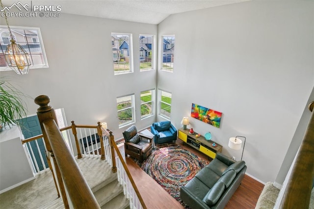 7942 French Rd, Colorado Springs, CO 80920 - living room with vaulted ceiling, baseboards, and a chandelier