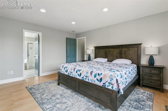 7942 French Rd, Colorado Springs, CO 80920 - bedroom with baseboards, light wood finished floors, recessed lighting, and ensuite bathroom