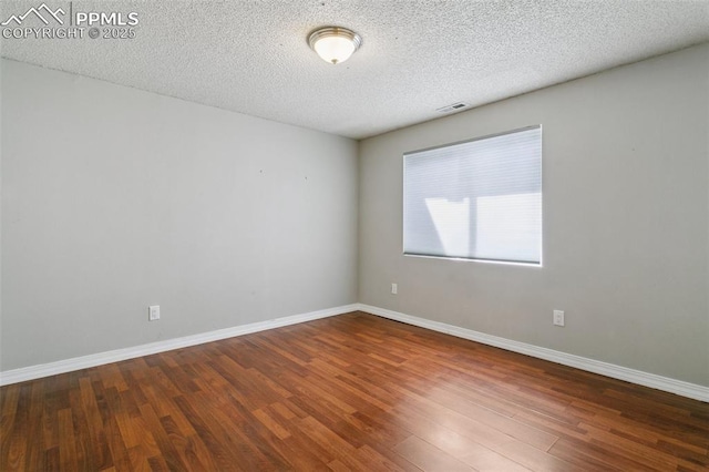 7942 French Rd, Colorado Springs, CO 80920 - spare room featuring wood finished floors, a textured ceiling, and baseboards