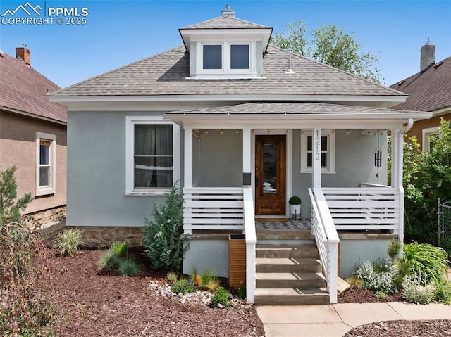 1212 W Cucharras St, Colorado Springs, CO 80904 - bungalow featuring a shingled roof, a porch, and stucco siding