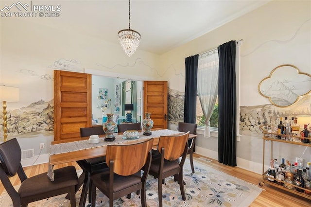 1212 W Cucharras St, Colorado Springs, CO 80904 - dining space with a chandelier, light wood-style floors, and baseboards