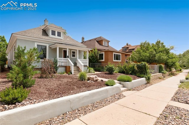1212 W Cucharras St, Colorado Springs, CO 80904 - bungalow-style home featuring a porch, stucco siding, a shingled roof, and a chimney