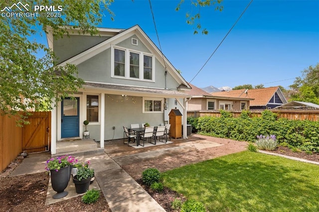1212 W Cucharras St, Colorado Springs, CO 80904 - rear view of house with stucco siding, cooling unit, a patio, and a gate