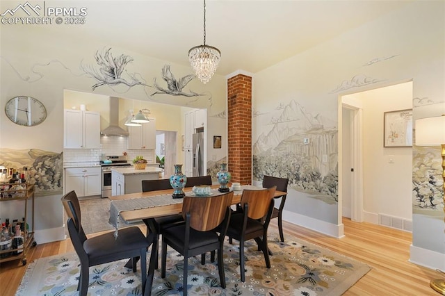 1212 W Cucharras St, Colorado Springs, CO 80904 - dining space with light wood finished floors, a chandelier, and baseboards
