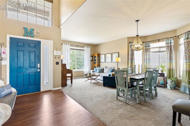6950 Blue Mesa Ln, Littleton, CO 80125 - dining space featuring a chandelier, wood finished floors, and baseboards