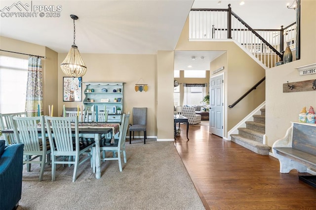 6950 Blue Mesa Ln, Littleton, CO 80125 - dining room featuring stairway, a chandelier, baseboards, and wood finished floors
