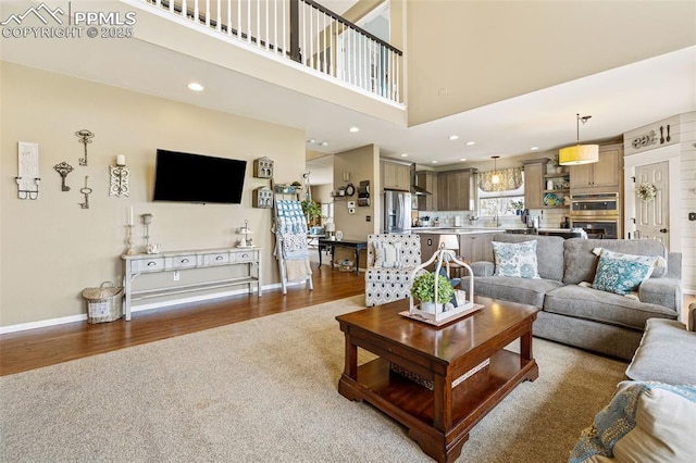 6950 Blue Mesa Ln, Littleton, CO 80125 - living room with wood finished floors, carpet, baseboards, a high ceiling, and recessed lighting