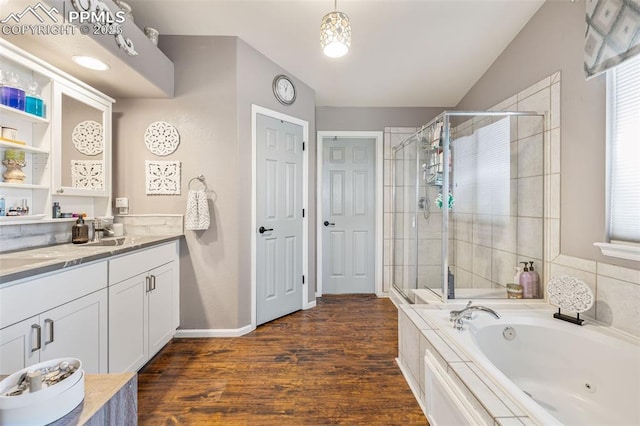 6950 Blue Mesa Ln, Littleton, CO 80125 - bathroom with a shower stall, a whirlpool tub, vanity, wood finished floors, and baseboards