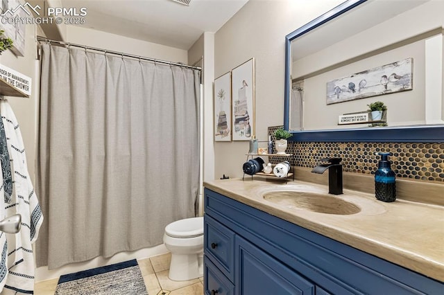 6950 Blue Mesa Ln, Littleton, CO 80125 - bathroom with vanity, toilet, backsplash, and tile patterned flooring