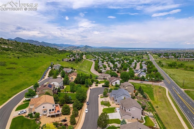 6950 Blue Mesa Ln, Littleton, CO 80125 - aerial view of property's location with nearby suburban area and a mountainous background
