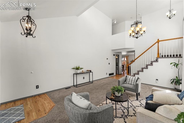 5481 Pioneer Mesa Dr, Colorado Springs, CO 80923 - living area with a chandelier, stairs, a towering ceiling, and wood finished floors