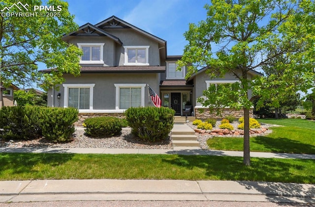 2512 Willow Glen Dr, Colorado Springs, CO 80920 - view of front of home with stucco siding, stone siding, and a front yard