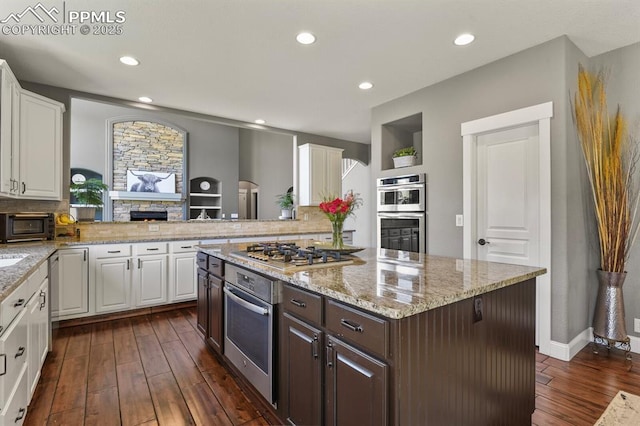 2512 Willow Glen Dr, Colorado Springs, CO 80920 - kitchen featuring stainless steel appliances, white cabinets, decorative backsplash, and recessed lighting
