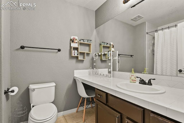 2512 Willow Glen Dr, Colorado Springs, CO 80920 - full bath featuring vanity, tile patterned flooring, toilet, baseboards, and a textured ceiling