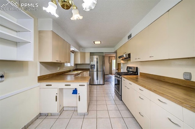 130 Cresta Rd, Colorado Springs, CO 80906 - kitchen featuring stainless steel appliances, wall chimney exhaust hood, a chandelier, a sink, and a textured ceiling