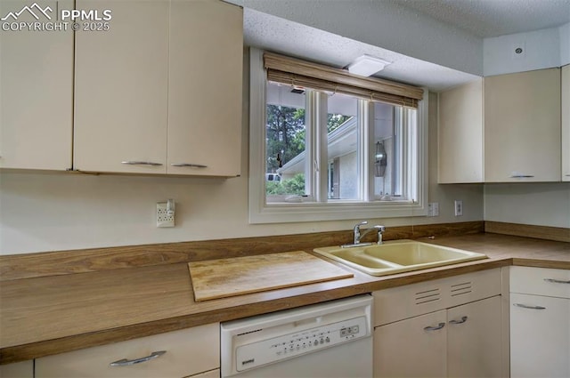 130 Cresta Rd, Colorado Springs, CO 80906 - kitchen with white dishwasher, a sink, white cabinets, and a textured ceiling