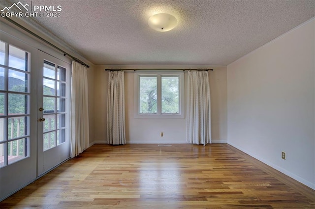 130 Cresta Rd, Colorado Springs, CO 80906 - spare room featuring a textured ceiling, wood finished floors, french doors, and baseboards