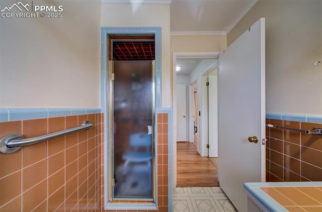 130 Cresta Rd, Colorado Springs, CO 80906 - bathroom with tile walls, crown molding, and wainscoting